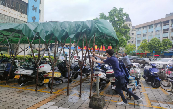 圖為員工正在拆除臨時(shí)搭建的遮陽(yáng)棚.png